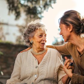 elderly women sin wheelchair speaking with her daughter