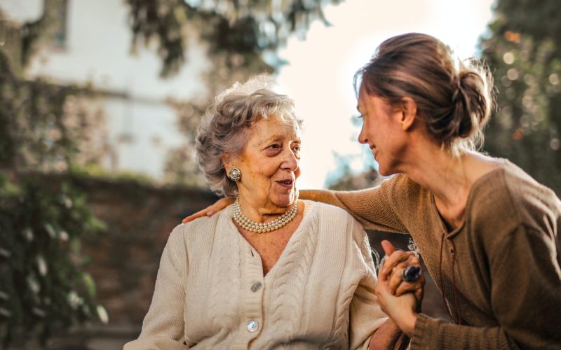 elderly women sin wheelchair speaking with her daughter